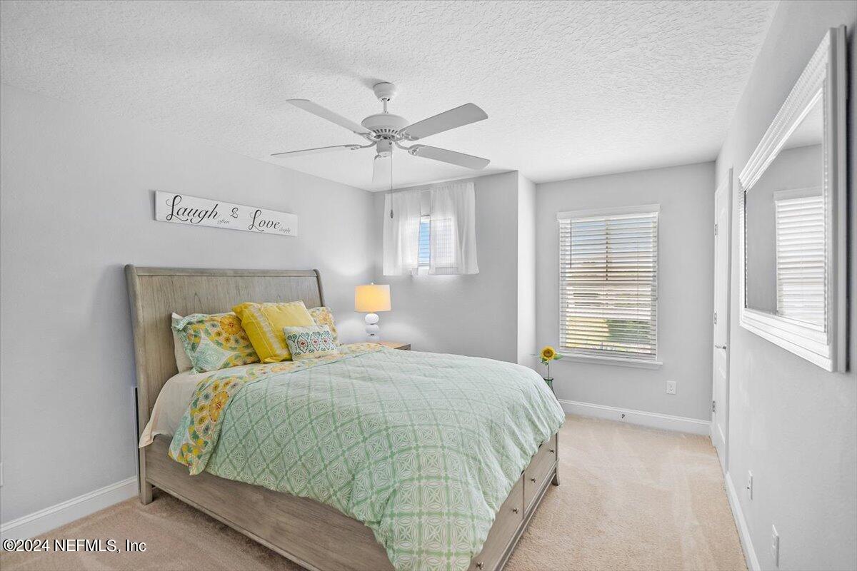 262 Clifton Bay Loop St. Johns, FL 32259 - Photo 24 of 57 a bedroom with a bed next to a window