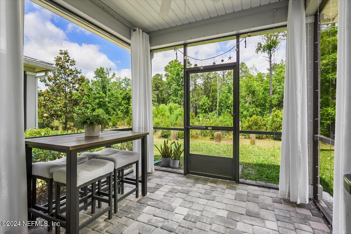 262 Clifton Bay Loop St. Johns, FL 32259 - Photo 33 of 57 a view of a porch with chairs and backyard