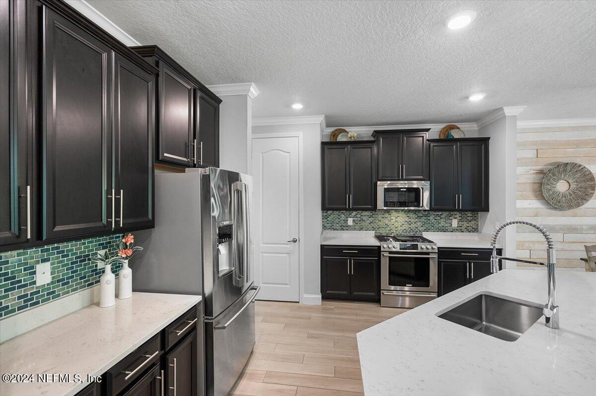 262 Clifton Bay Loop St. Johns, FL 32259 - Photo 9 of 57 a kitchen with stainless steel appliances granite countertop a sink stove and refrigerator