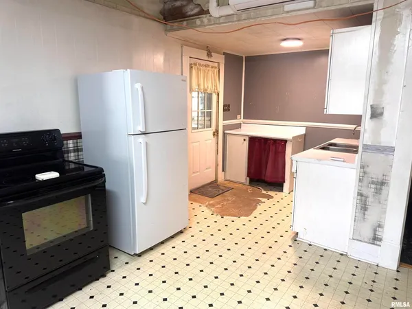 a kitchen with a refrigerator and a stove