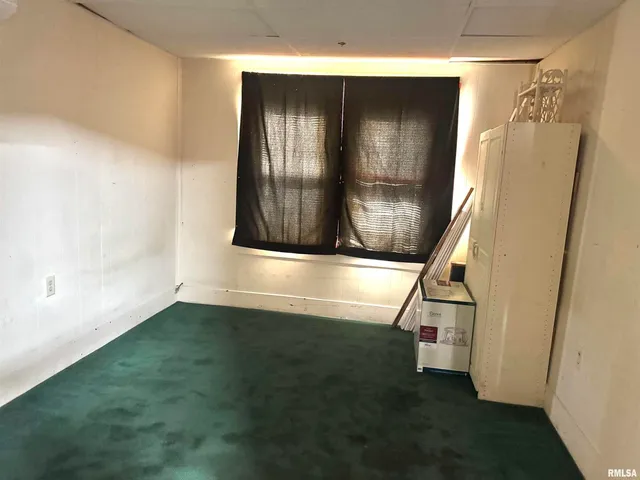 a view of an entryway with wooden floor and door