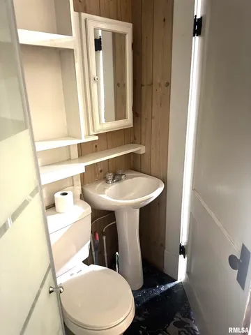 a bathroom with a sink toilet and mirror