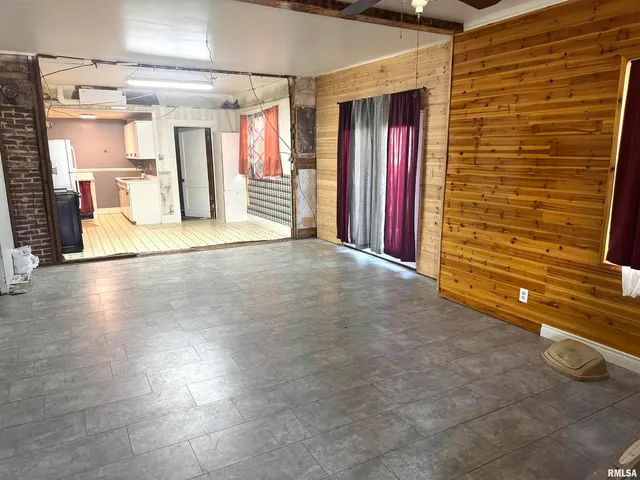 a view of an empty room with a fireplace