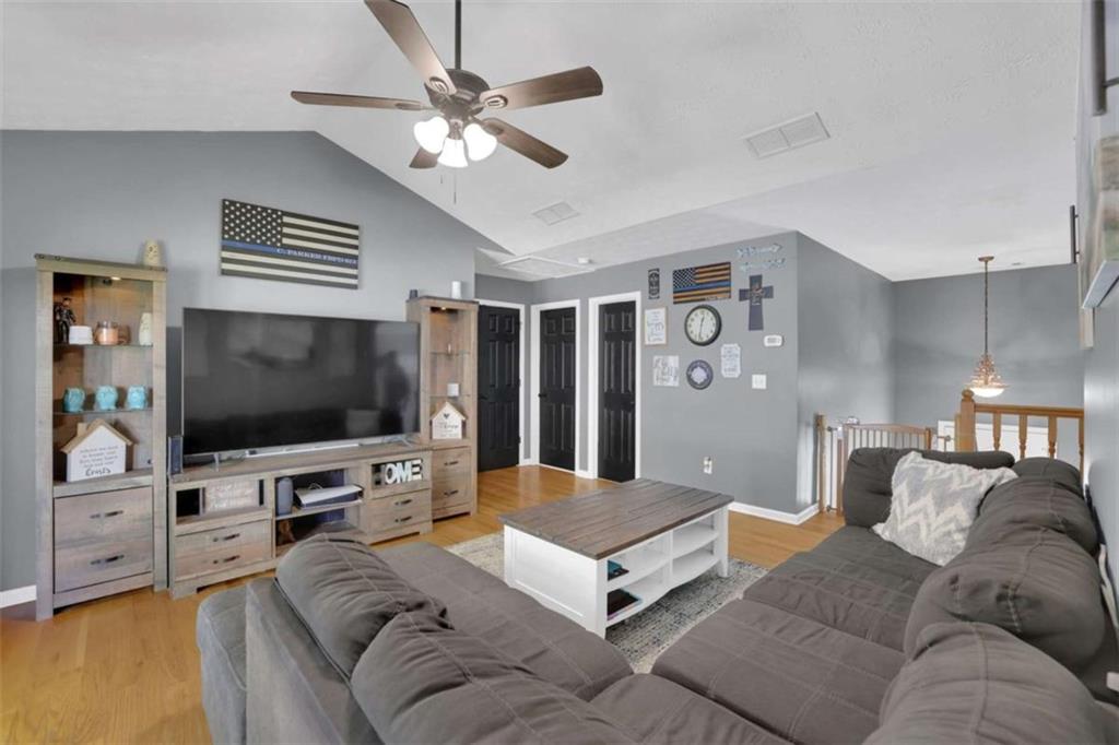 2932 Lake Hollow Road Gainesville, GA 30501 - Photo 11 of 68 a living room with furniture and a flat screen tv