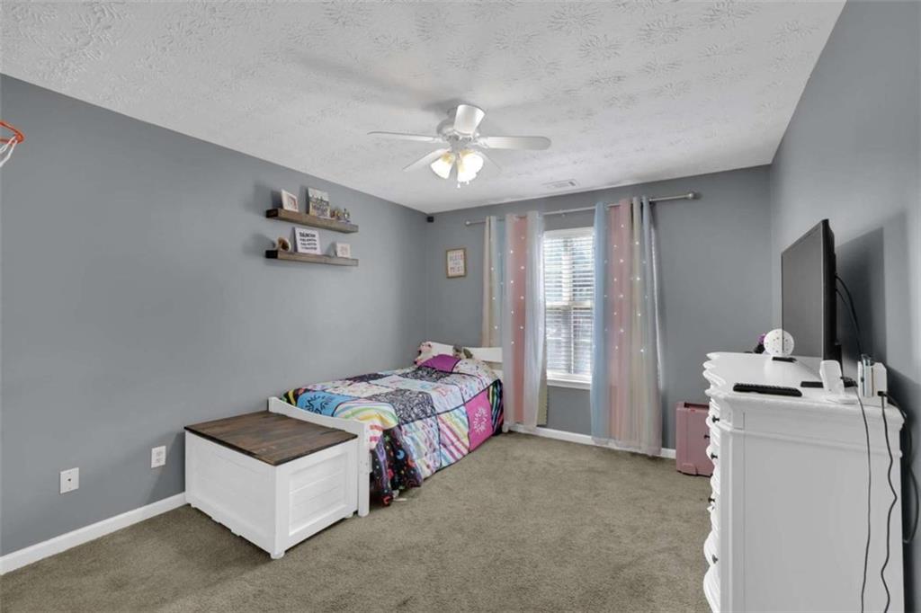 2932 Lake Hollow Road Gainesville, GA 30501 - Photo 13 of 68 a bedroom with a bed and a flat screen tv
