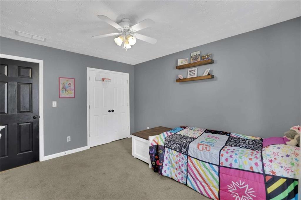 2932 Lake Hollow Road Gainesville, GA 30501 - Photo 14 of 68 a bedroom with a bed and a chandelier