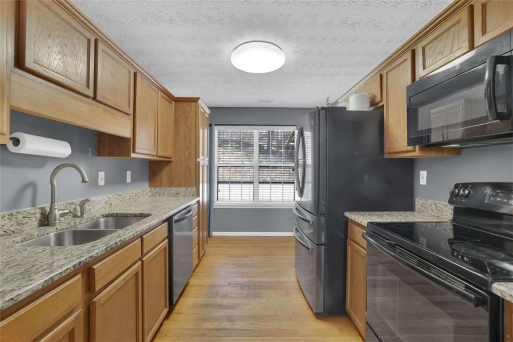 2932 Lake Hollow Road Gainesville, GA 30501 - Photo 16 of 68 a kitchen with stainless steel appliances granite countertop a sink and a stove