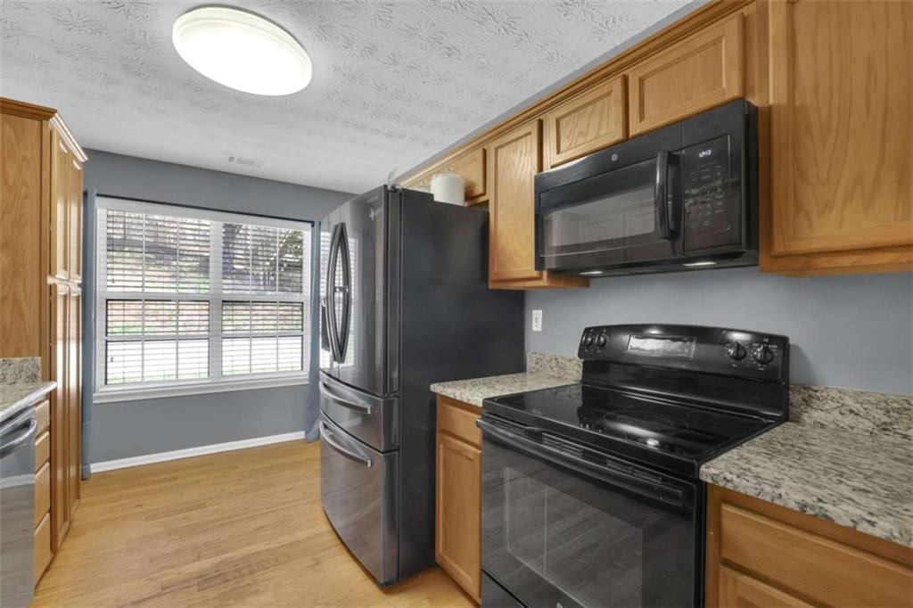 2932 Lake Hollow Road Gainesville, GA 30501 - Photo 18 of 68 a kitchen with a stove microwave and sink