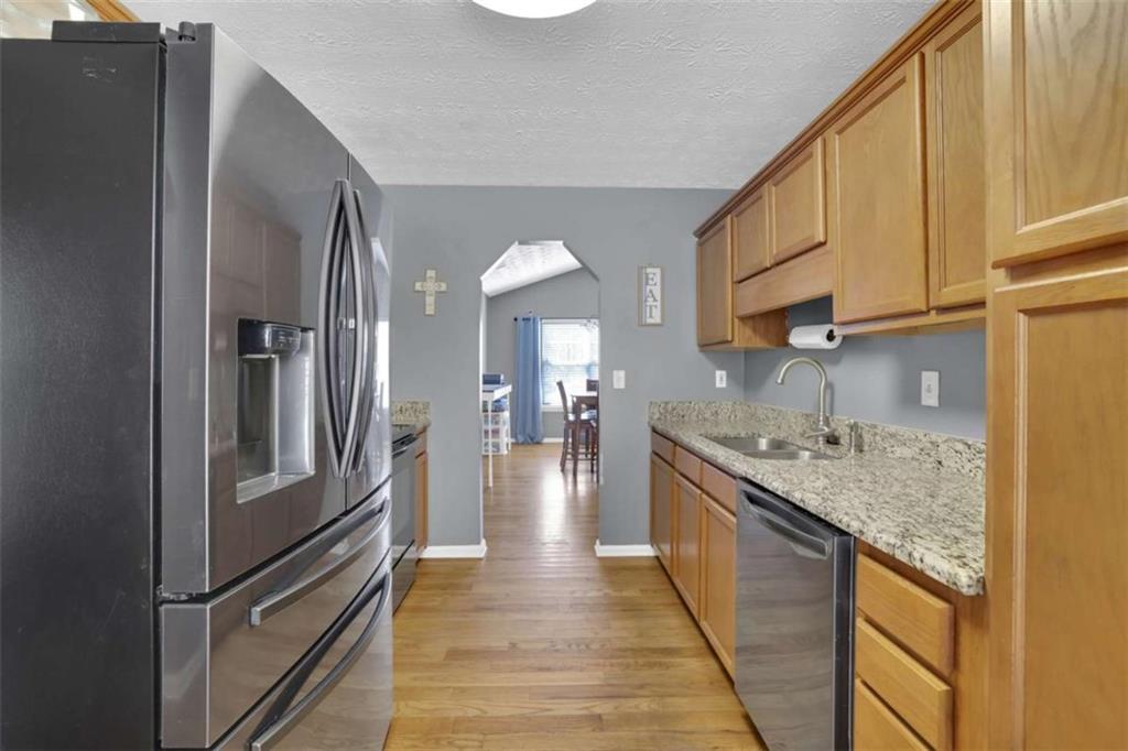 2932 Lake Hollow Road Gainesville, GA 30501 - Photo 21 of 68 a kitchen with stainless steel appliances granite countertop a refrigerator a sink and a stove