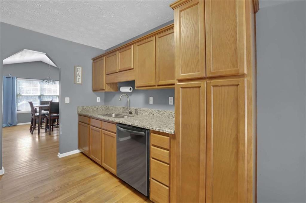 2932 Lake Hollow Road Gainesville, GA 30501 - Photo 22 of 68 a kitchen with stainless steel appliances granite countertop a sink and cabinets