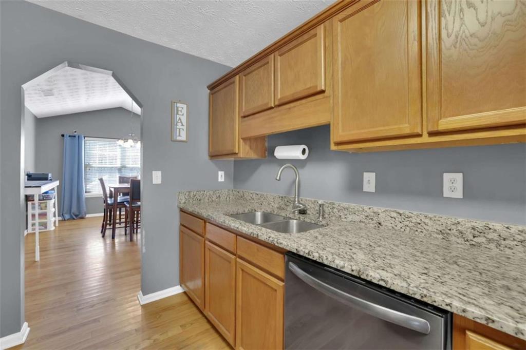 2932 Lake Hollow Road Gainesville, GA 30501 - Photo 23 of 68 a kitchen with stainless steel appliances granite countertop a sink and cabinets