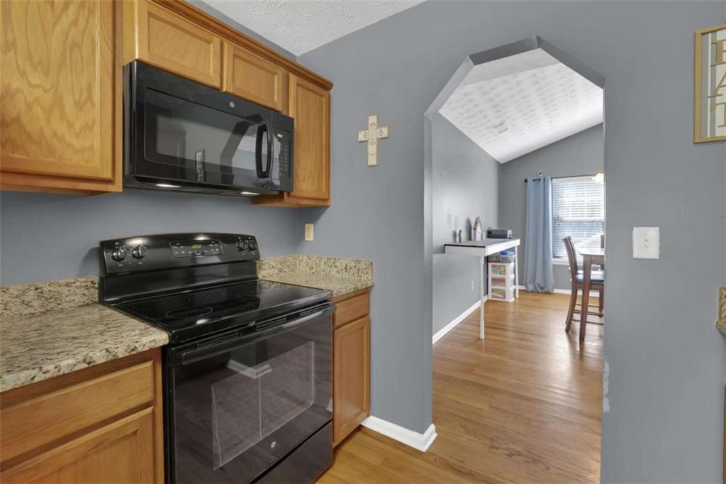 2932 Lake Hollow Road Gainesville, GA 30501 - Photo 24 of 68 a kitchen with a stove and a microwave