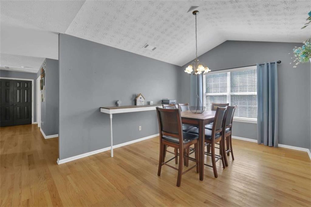 2932 Lake Hollow Road Gainesville, GA 30501 - Photo 25 of 68 a view of a dining room with furniture window and wooden floor