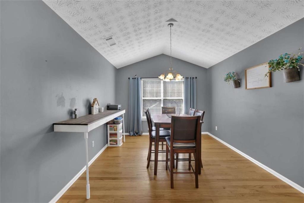 2932 Lake Hollow Road Gainesville, GA 30501 - Photo 26 of 68 a view of a dining room with furniture window and wooden floor