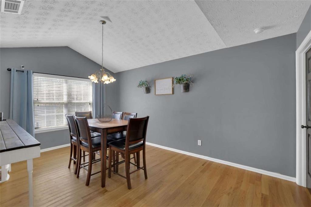 2932 Lake Hollow Road Gainesville, GA 30501 - Photo 27 of 68 a view of a dining room with furniture window and wooden floor