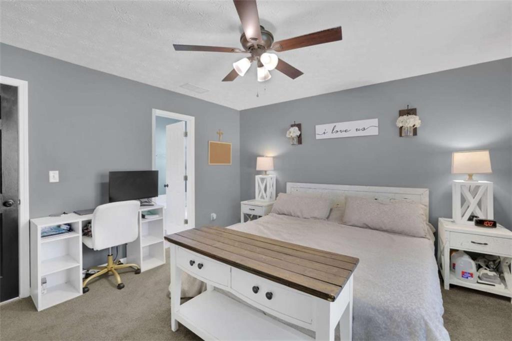 2932 Lake Hollow Road Gainesville, GA 30501 - Photo 31 of 68 a living room with a bed furniture and a flat screen tv