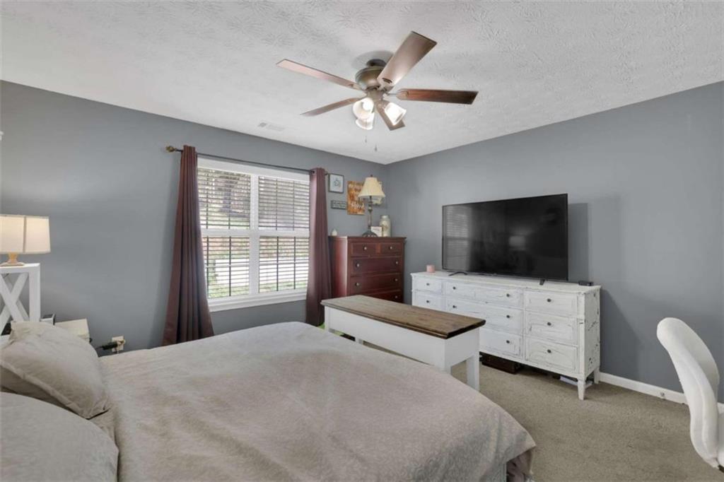 2932 Lake Hollow Road Gainesville, GA 30501 - Photo 33 of 68 a bedroom with a bed and a flat screen tv