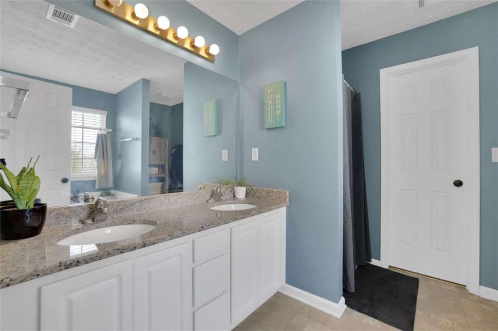 2932 Lake Hollow Road Gainesville, GA 30501 - Photo 35 of 68 a bathroom with a sink and a mirror