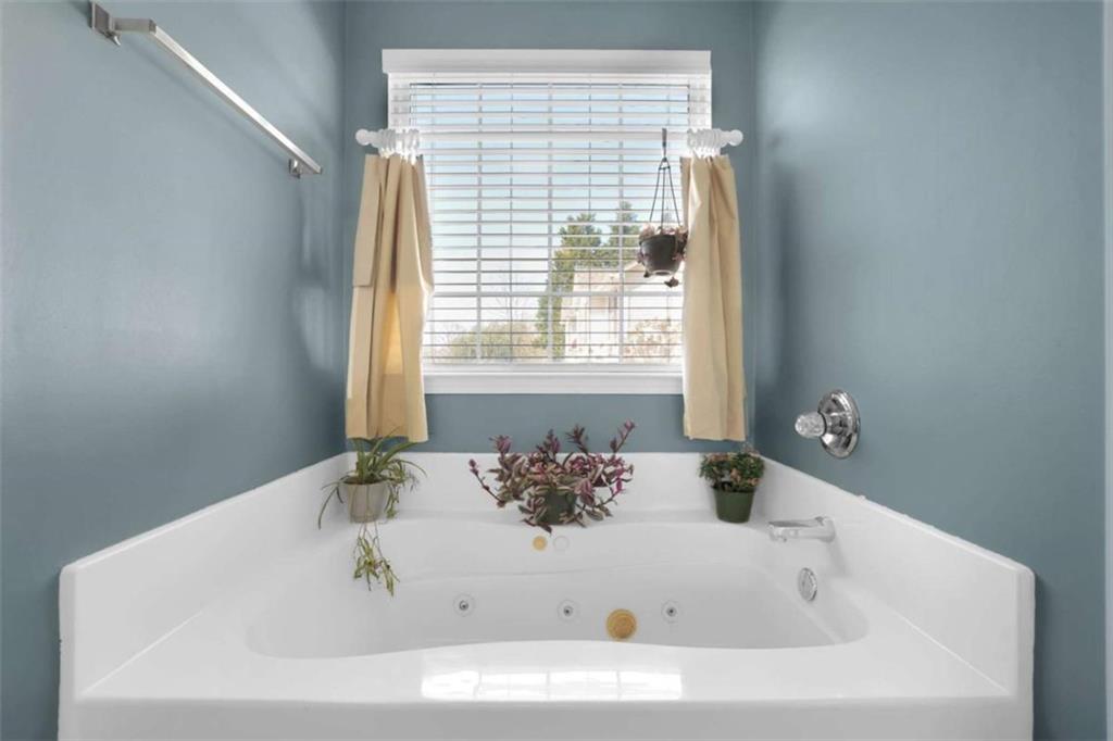 2932 Lake Hollow Road Gainesville, GA 30501 - Photo 37 of 68 a white bath tub sitting in a bathroom next to a window