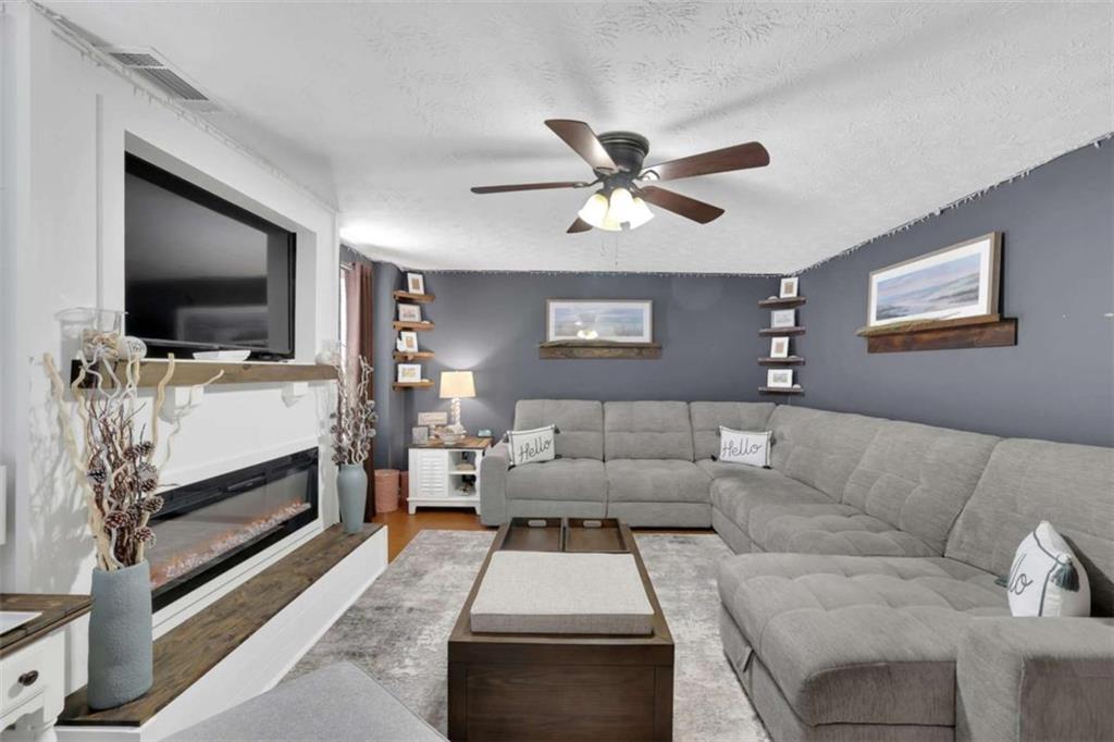 2932 Lake Hollow Road Gainesville, GA 30501 - Photo 43 of 68 a living room with furniture and a flat screen tv