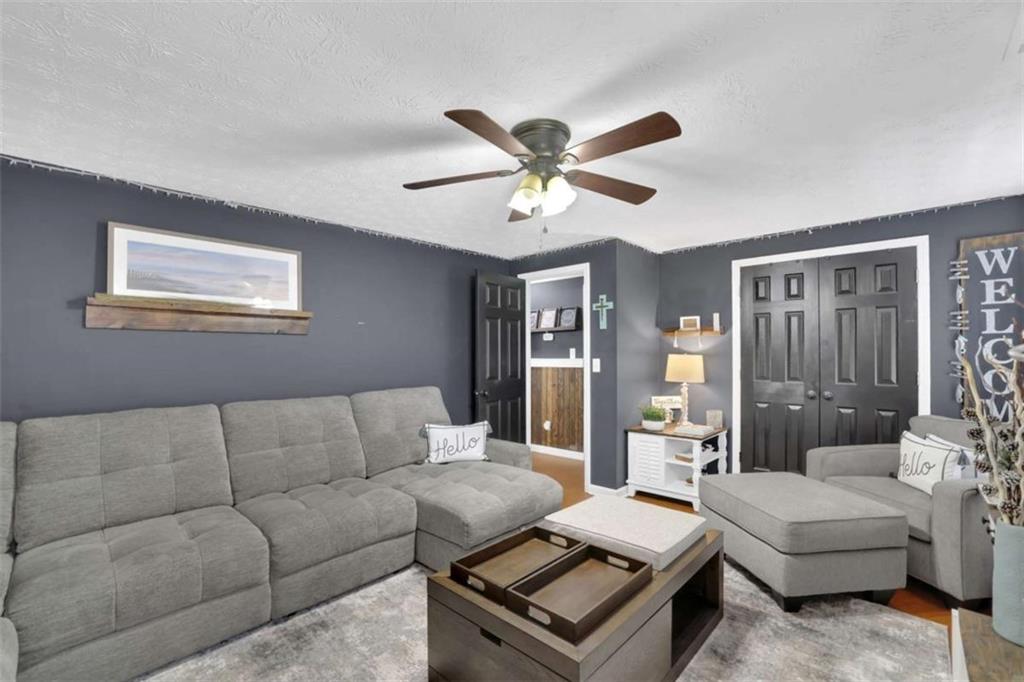 2932 Lake Hollow Road Gainesville, GA 30501 - Photo 44 of 68 a living room with furniture and a chandelier