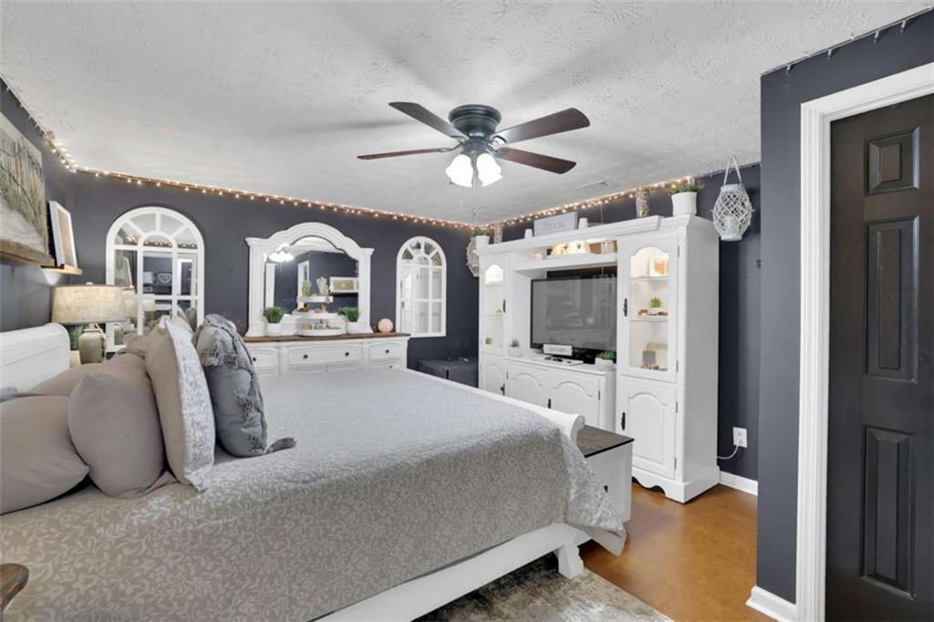 2932 Lake Hollow Road Gainesville, GA 30501 - Photo 49 of 68 a bedroom with a bed and ceiling fan