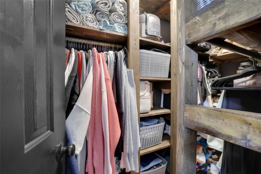 2932 Lake Hollow Road Gainesville, GA 30501 - Photo 51 of 68 a view of walk in closet with clothes and shoes