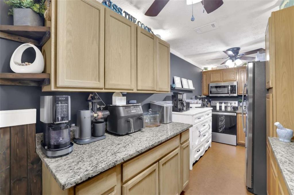 2932 Lake Hollow Road Gainesville, GA 30501 - Photo 54 of 68 a kitchen with granite countertop a sink stainless steel appliances and cabinets