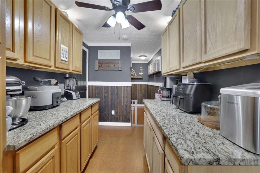 2932 Lake Hollow Road Gainesville, GA 30501 - Photo 56 of 68 a kitchen with stainless steel appliances granite countertop a sink stove and refrigerator