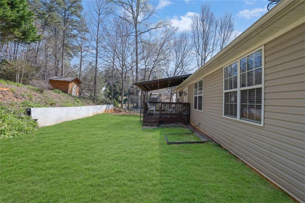 2932 Lake Hollow Road Gainesville, GA 30501 - Photo 59 of 68 a view of backyard with table and chairs and potted plants