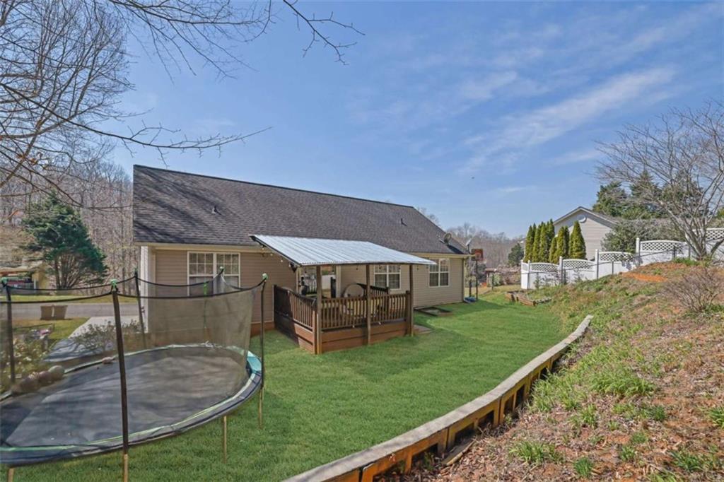 2932 Lake Hollow Road Gainesville, GA 30501 - Photo 61 of 68 a backyard of a house with table and chairs