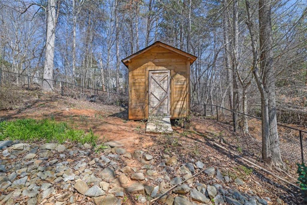 2932 Lake Hollow Road Gainesville, GA 30501 - Photo 62 of 68 a stone house with trees in front of it