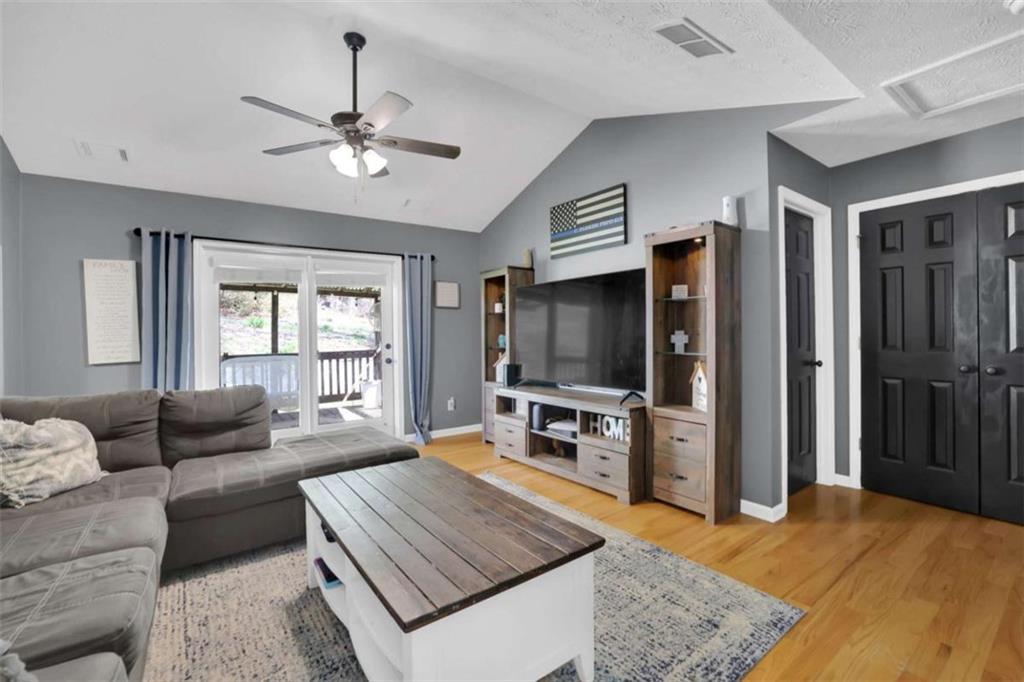 2932 Lake Hollow Road Gainesville, GA 30501 - Photo 8 of 68 a living room with furniture and a flat screen tv