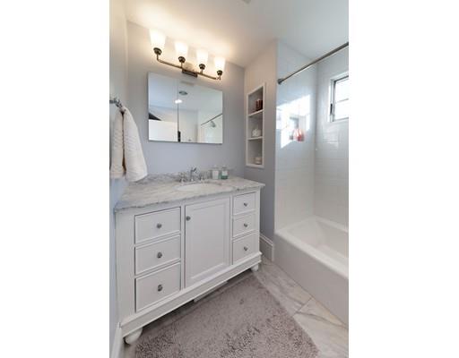 39 Rangeley Road Newton, MA 02465 - Photo 11 of 16 a spacious bathroom with a granite countertop sink a mirror and a