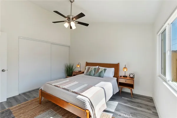 a bedroom with a bed and a window
