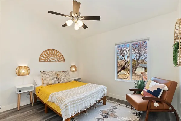 a bedroom with a bed and painting on the wall