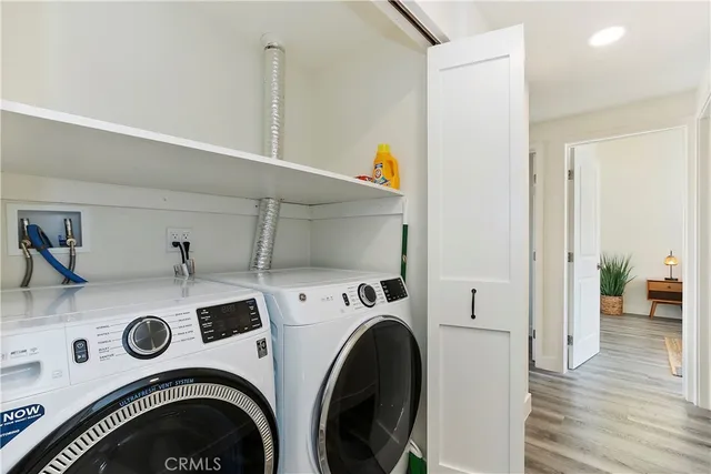a view of washer and dryer with kitchen in the background