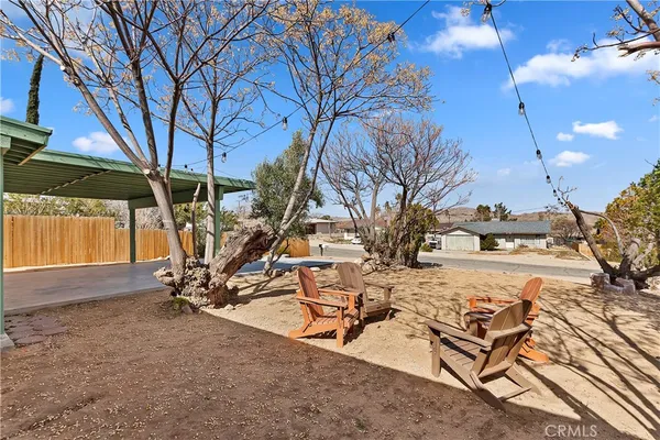 a view of a backyard with wooden fence