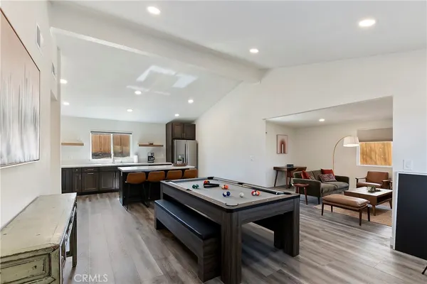 a living room with furniture a rug and a table