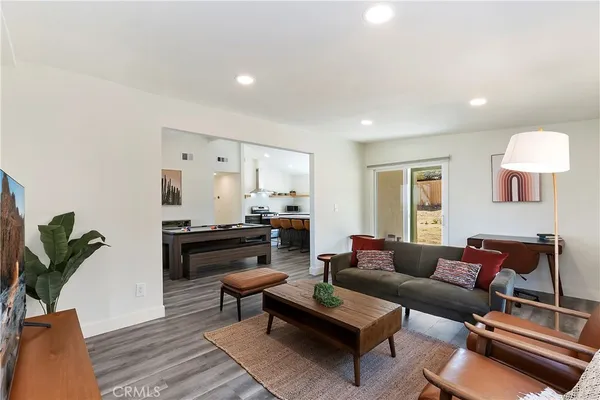 a living room with furniture rug and wooden floor