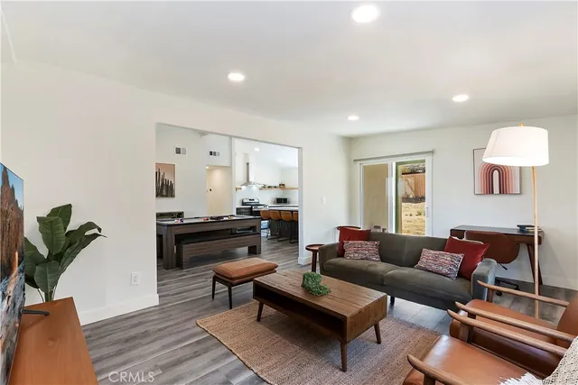 a living room with furniture rug and wooden floor