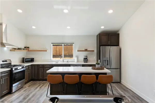 a kitchen with a sink cabinets and wooden floor