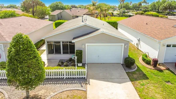 a view of a house with a yard and porch