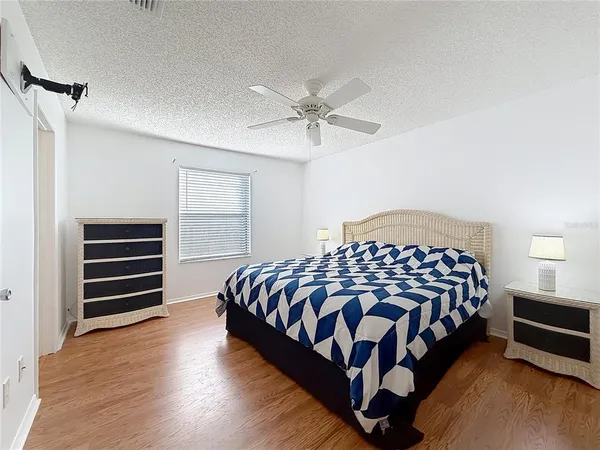 a bedroom with a bed and a chandelier