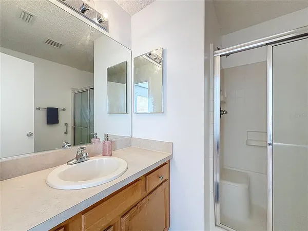 a bathroom with a double vanity sink and mirror