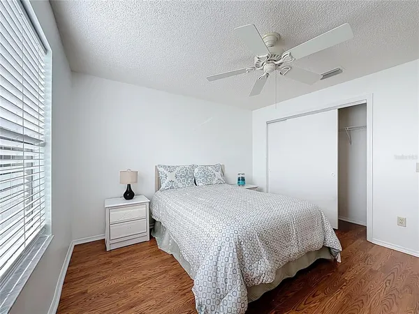 a bedroom with a large bed and a chandelier