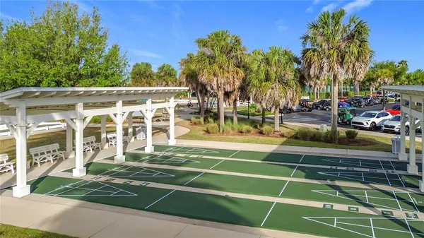 a view of a swimming pool with a lawn chairs and a lawn chairs