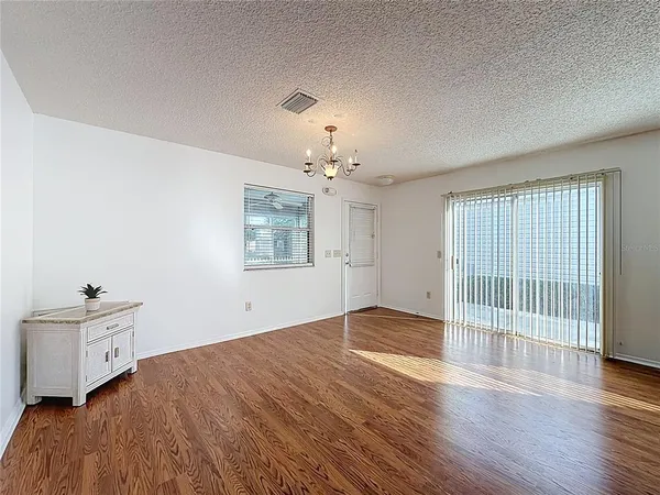 a view of a room with lounge chair and wooden floor