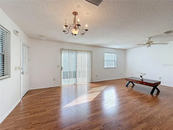 a living room with furniture a table and wooden floor