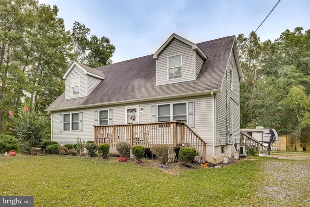 a view of a house with a yard and sitting area